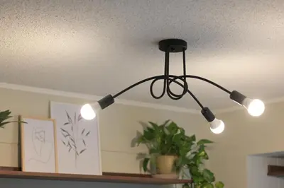 a black light fixture hanging from a ceiling at Cozy apartment in Barranco in Lima