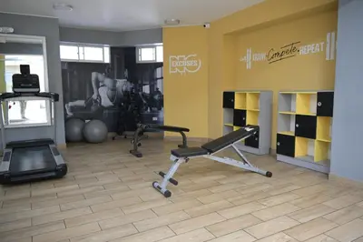 a gym with a treadmill and weights in a room at Cozy apartment in Barranco in Lima
