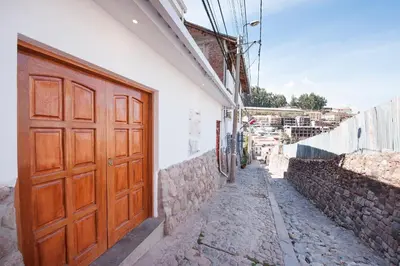 a wooden door on the side of a building at Carmen's House in Cusco