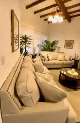 a living room with a couch with pillows on it at Casa Trasgu en Cieneguilla Lima Peru Nice and cozy cottage in Villa María del Trunfo