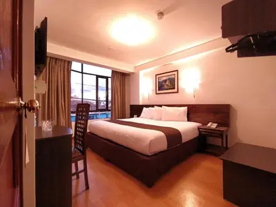 a hotel room with a bed and a window at Illas Inn in Cusco