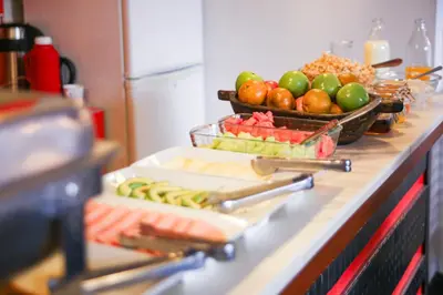 a counter with a bunch of fruits and vegetables on it at Illas Inn in Cusco