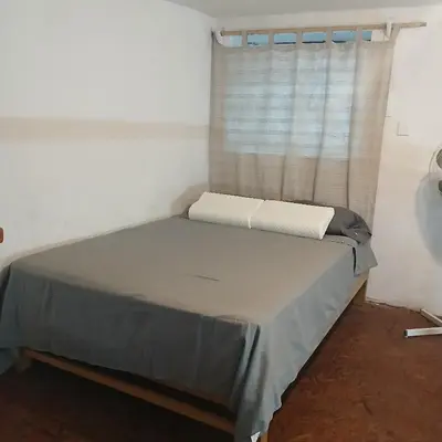 a bed in a room with a window at Casita Monarca in San Antonio