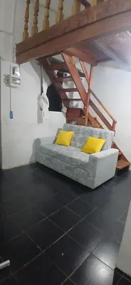 a bed with yellow pillows sitting on a floor at Casita Monarca in San Antonio