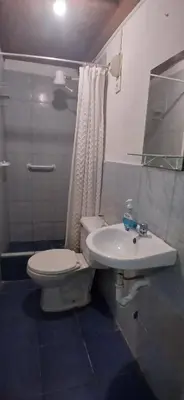 a bathroom with a toilet and a sink at Casita Monarca in San Antonio