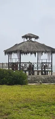 a pavilion with a straw hut on the beach at SKY HOUSE con vista al mar in Chincha Baja