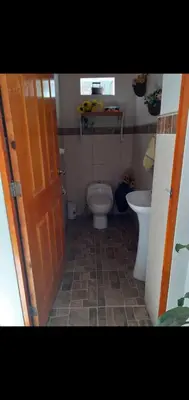 a bathroom with a toilet and a sink at Noah'house in Nazca