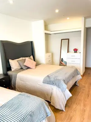 a bedroom with two beds and a mirror in it at Ocean view 1 BR Miraflores with parking in Lima