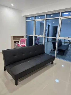 a black couch in a room with windows at 501 Modern equipped department 3 in Abancay