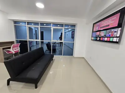 a living room with a black couch and a television at 501 Modern equipped department 3 in Abancay