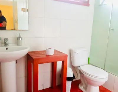 a bathroom with a white toilet and a sink at Miraflores Larco in Lima