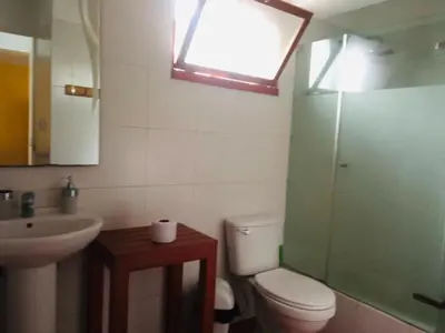 a bathroom with a toilet and a sink and a window at Miraflores Larco in Lima