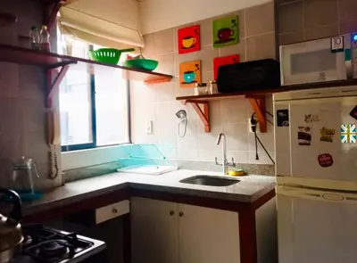 a small kitchen with a sink and a refrigerator at Miraflores Larco in Lima