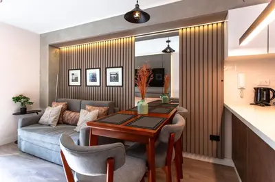 a living room with a table and a couch at Brand-new designer apt - Pool in Miraflores in Lima