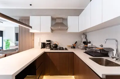a kitchen with white cabinets and a sink at Brand-new designer apt - Pool in Miraflores in Lima