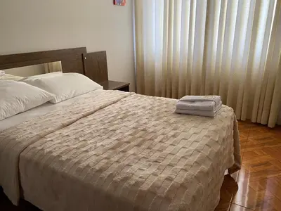 a bedroom with a bed with a towel on it at Amanecer Refugio Ideal Cozy Retreat in Los Olivos in Lima