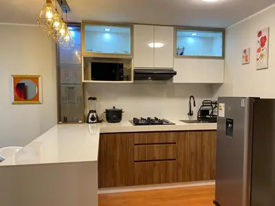 a kitchen with white counters and a stainless steel refrigerator at Amanecer Refugio Ideal Cozy Retreat in Los Olivos in Lima