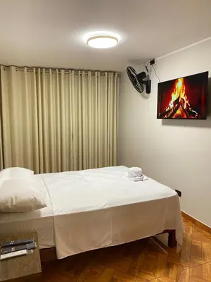 a bedroom with a bed and a painting on the wall at Amanecer Refugio Ideal Cozy Retreat in Los Olivos in Lima
