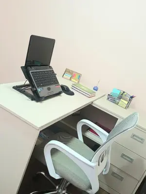 a laptop computer sitting on a desk with a chair at Katty's apartment - Las Malvas in Lima