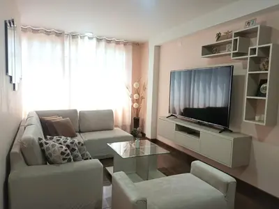 a living room with a couch and a tv at Katty's apartment - Las Malvas in Lima