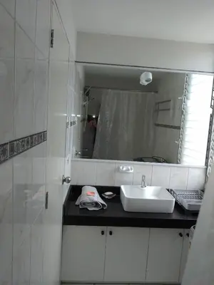 a bathroom with a sink and a mirror at Miraflores, Lima, habitación independiente in San Antonio