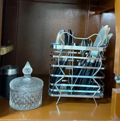 a rack of dishes sitting on a shelf next to a container at El Encanto Espacio Calido A warm space in Los Olivos in Lima