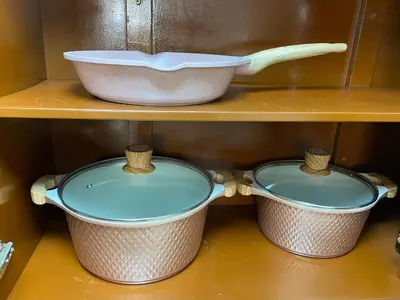 two pots and pans on a shelf with a bowl at El Encanto Espacio Calido A warm space in Los Olivos in Lima