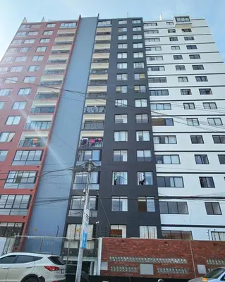 a tall building with windows on the side of it at Suite Ocean View con WiFi San Miguel 1502 in Lima