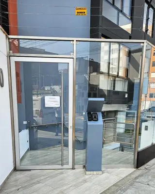 a glass door with a trash can in front of a building at Suite Ocean View con WiFi San Miguel 1502 in Lima