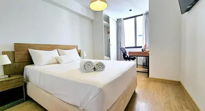 a bedroom with a bed with two towels on it at Suite Ocean View con WiFi San Miguel 1502 in Lima