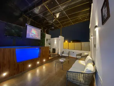 a living room with a couch and a large tv at Brisa Dorada - Luxury Apartment in Los Olivos in Lima