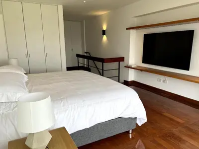 a bedroom with a bed and a flat screen tv at Luxury Duplex Stunning Golf Views - Prime Location in Lima
