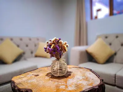 a vase with flowers sitting on a wooden table at Casa Aguilar in Urubamba