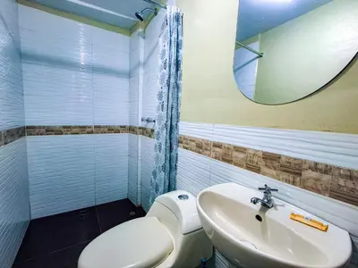 a bathroom with a toilet and a sink and a mirror at Casa Aguilar in Urubamba