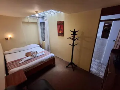 a bedroom with a bed with a towel on it at Andean Dreams 1 in Cusco