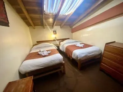 a hotel room with two beds with towels on them at Andean Dreams 1 in Cusco