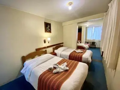 a hotel room with two beds with towels on them at Andean Dreams 1 in Cusco