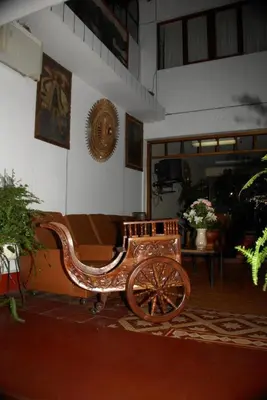 a wooden horse drawn carriage in a building at Hotel WhiteHouse in Cusco