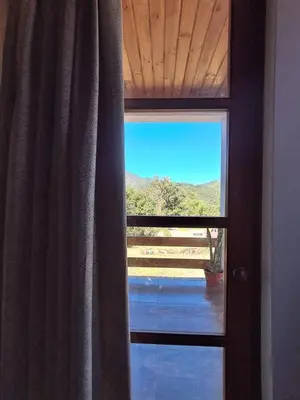 a window with a view of a mountain view at Bellavista Hospedaje in Oxapampa