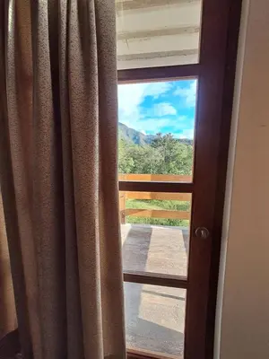 a window with a view of a mountain view at Bellavista Hospedaje in Oxapampa