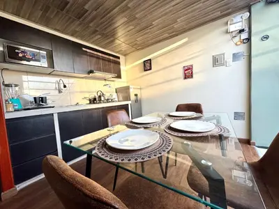 a dining room with a table and chairs in a kitchen at Casa Cusco in Cusco