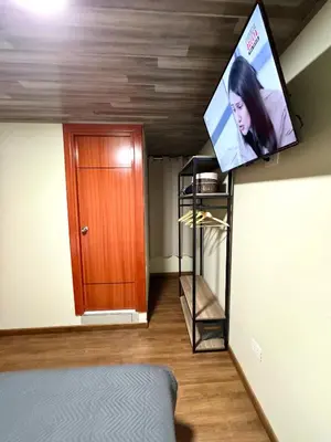 a flat screen tv hanging on the ceiling of a room at Casa Cusco in Cusco