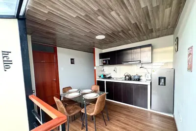 a kitchen and dining room with a table and chairs at Casa Cusco in Cusco