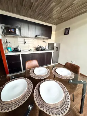 a kitchen with a table with four plates on it at Casa Cusco in Cusco