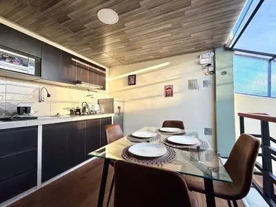 a dining room with a table and chairs in a kitchen at Casa Cusco in Cusco