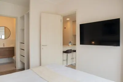 a bedroom with a bed with a tv on a wall at Salaverry by Wynwood House in Lima