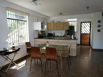 a kitchen and dining room with a table and chairs at Nice country house with pool and beautiful view in Huarochirí