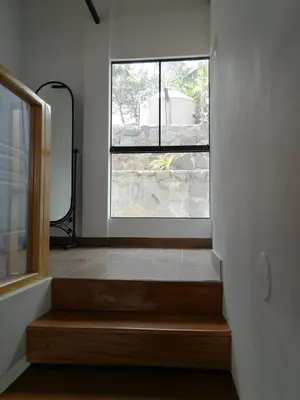 a staircase in a room with a window at Nice country house with pool and beautiful view in Huarochirí
