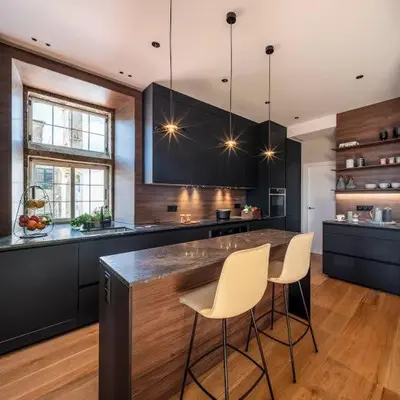 a kitchen with a large island with white bar chairs at Magnum House in Huancayo