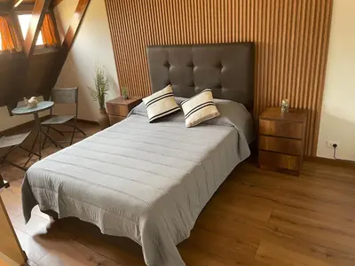 a bedroom with a large bed with two pillows at SAELUMA Suite Apart in Lima